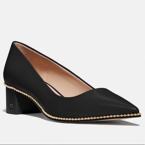 Willa black leather Coach pumps with gold detail.